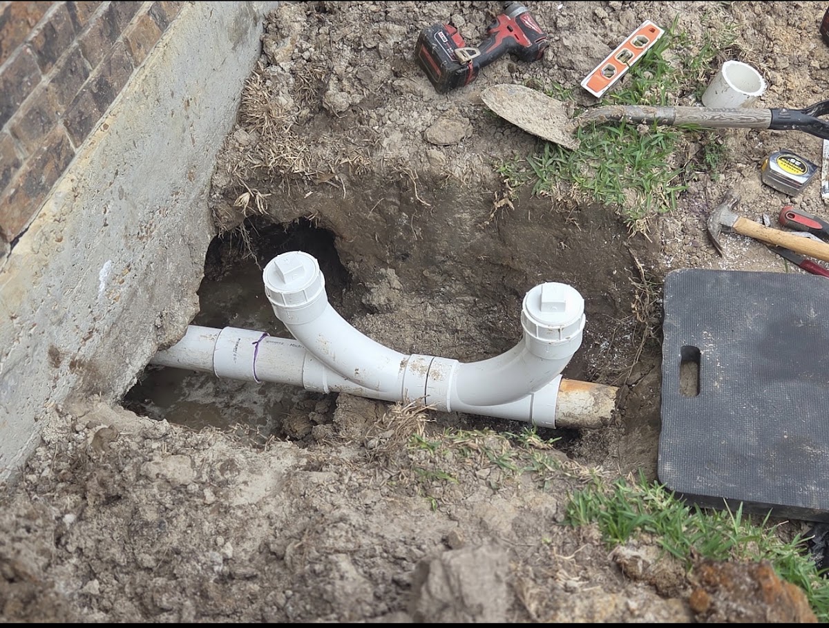 Newly laid PVC sewer pipe in an excavated trench