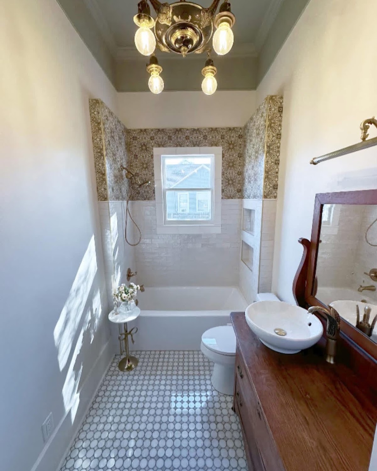 Finished bathroom with tub, patterned tile floor and vessel sink