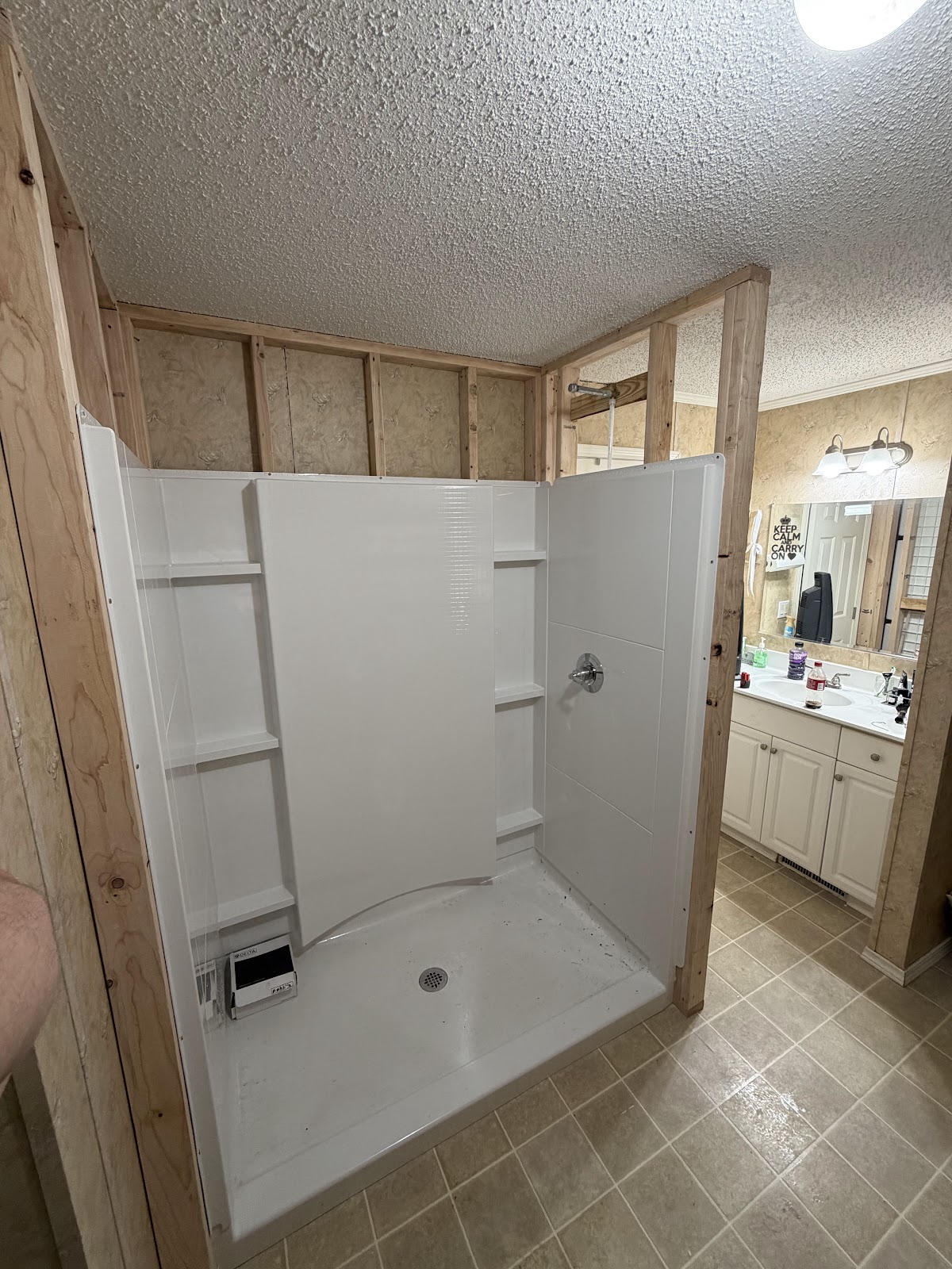 One piece shower unit being fitted into a framed wall